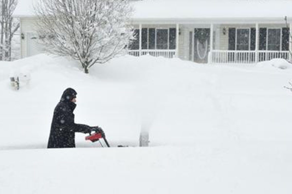 0_0001_snow Person snowblowing deep snow in front yard.