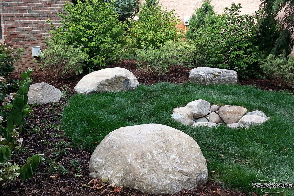 Garden with rocks and a small fire pit.