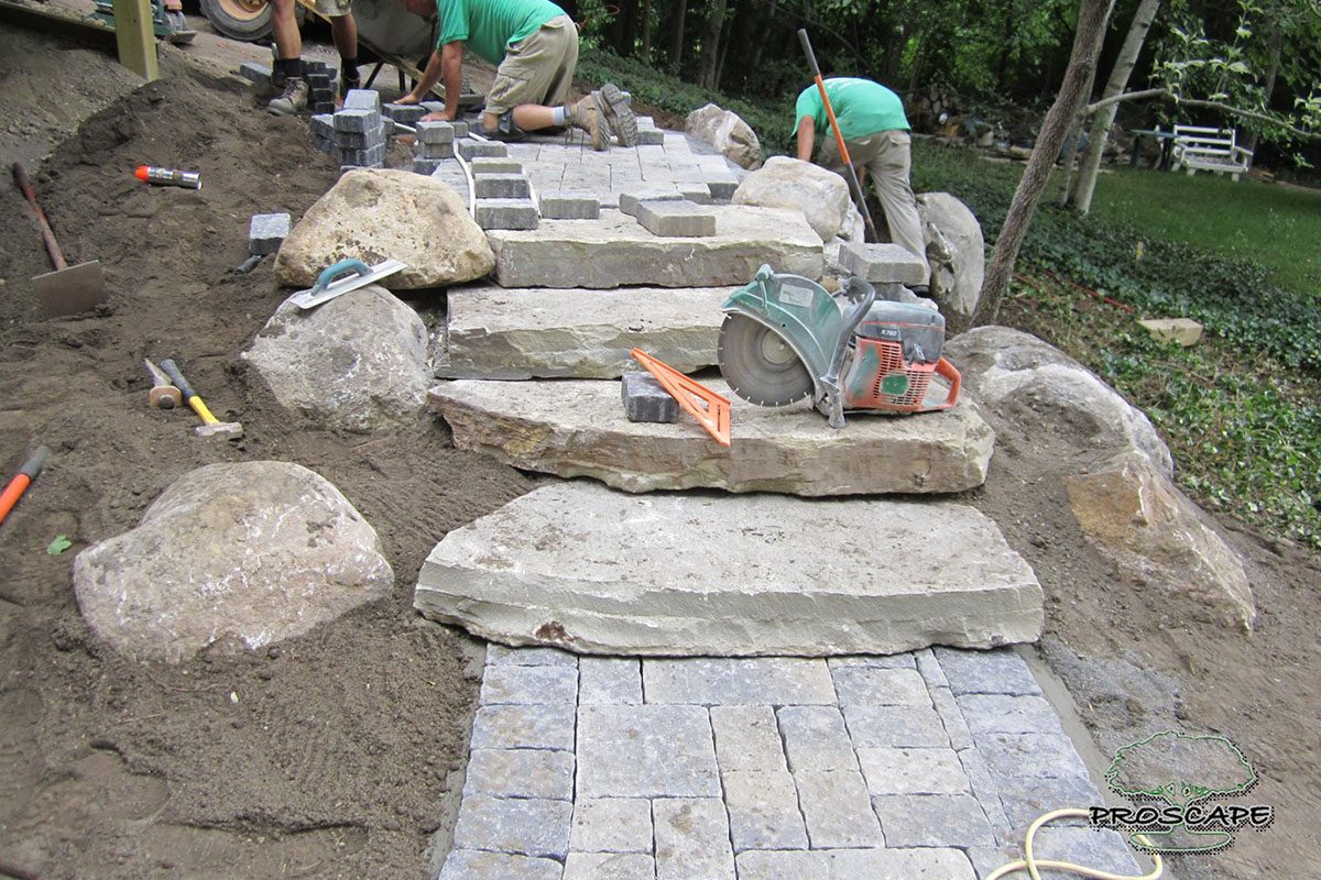0_0004_land--2 Stone pathway under construction with tools.