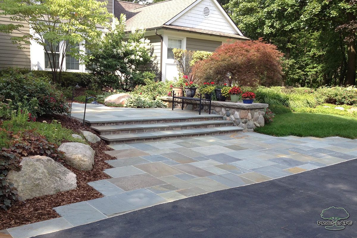 House entrance with steps and garden landscaping.