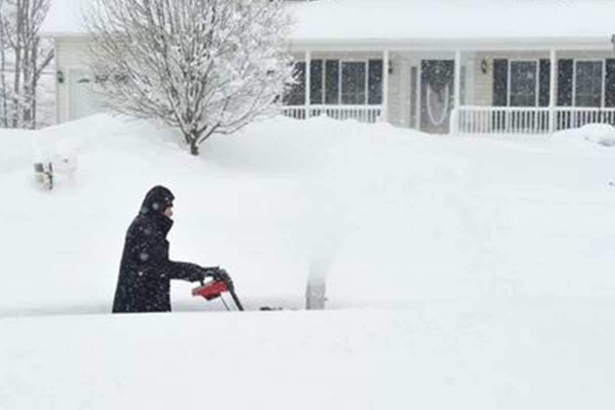 0_0006_snow Person using snowblower in heavy snowfall.