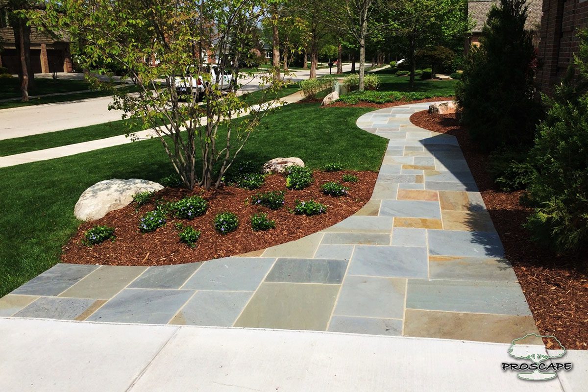 Curved stone pathway with landscaped garden.