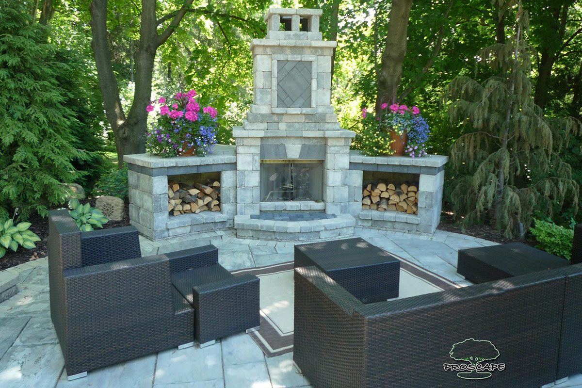 Outdoor patio with fireplace and seating area.