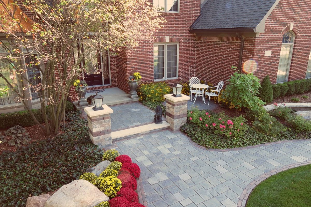 Brick house with landscaped front yard and patio.