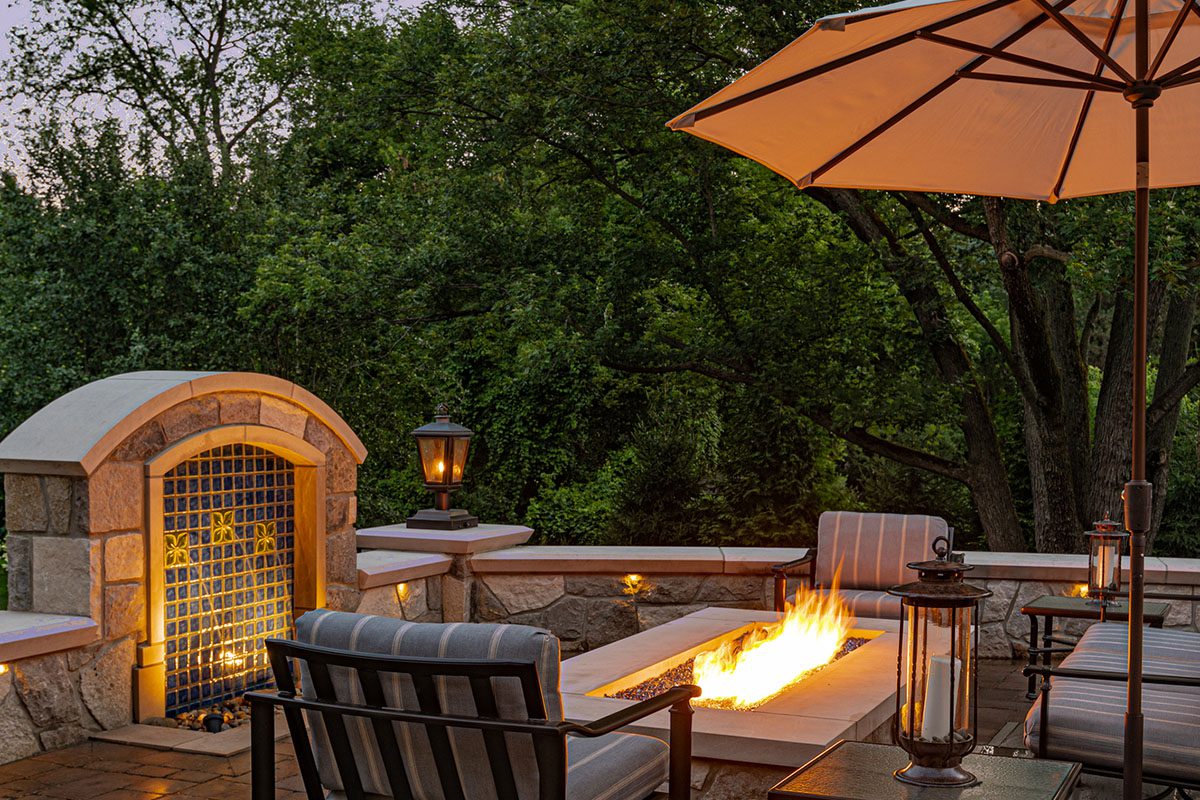 Patio with fire pit and outdoor seating.