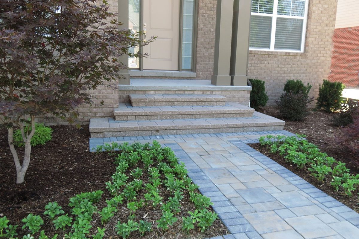 Brick steps and walkway with greenery.