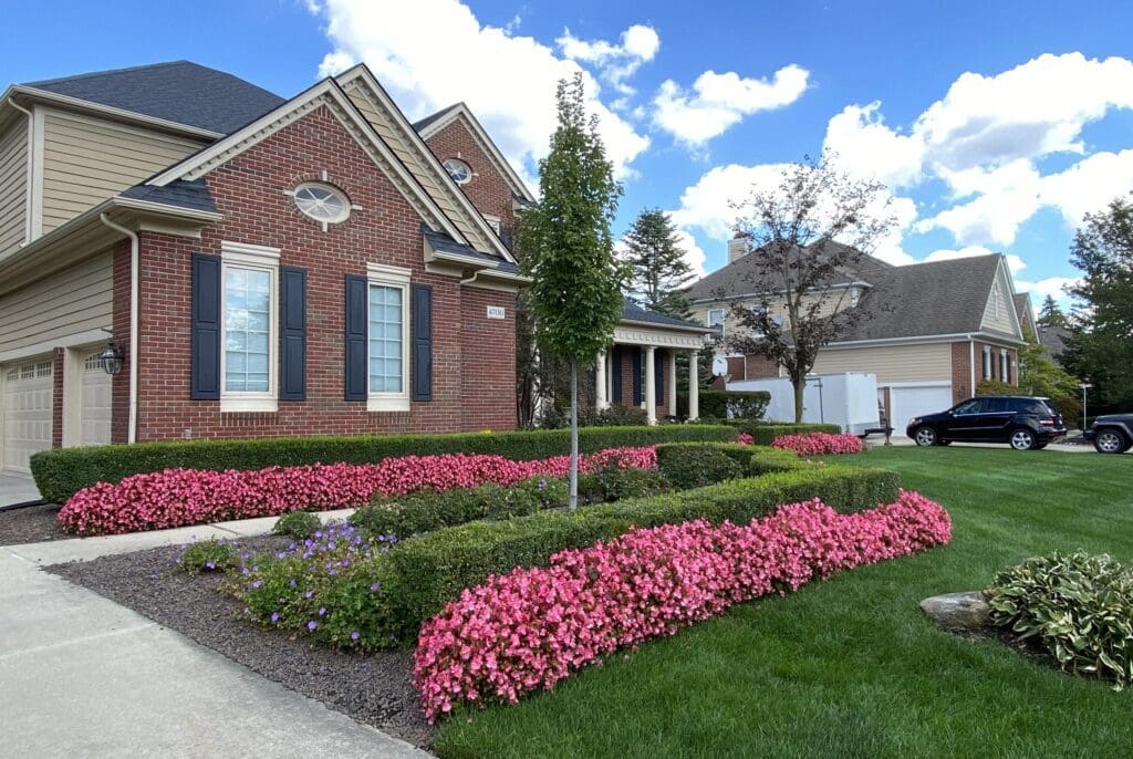 Brick house with garden and driveway.