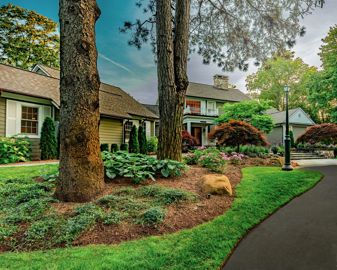 env-1 Charming house with landscaped garden and trees.