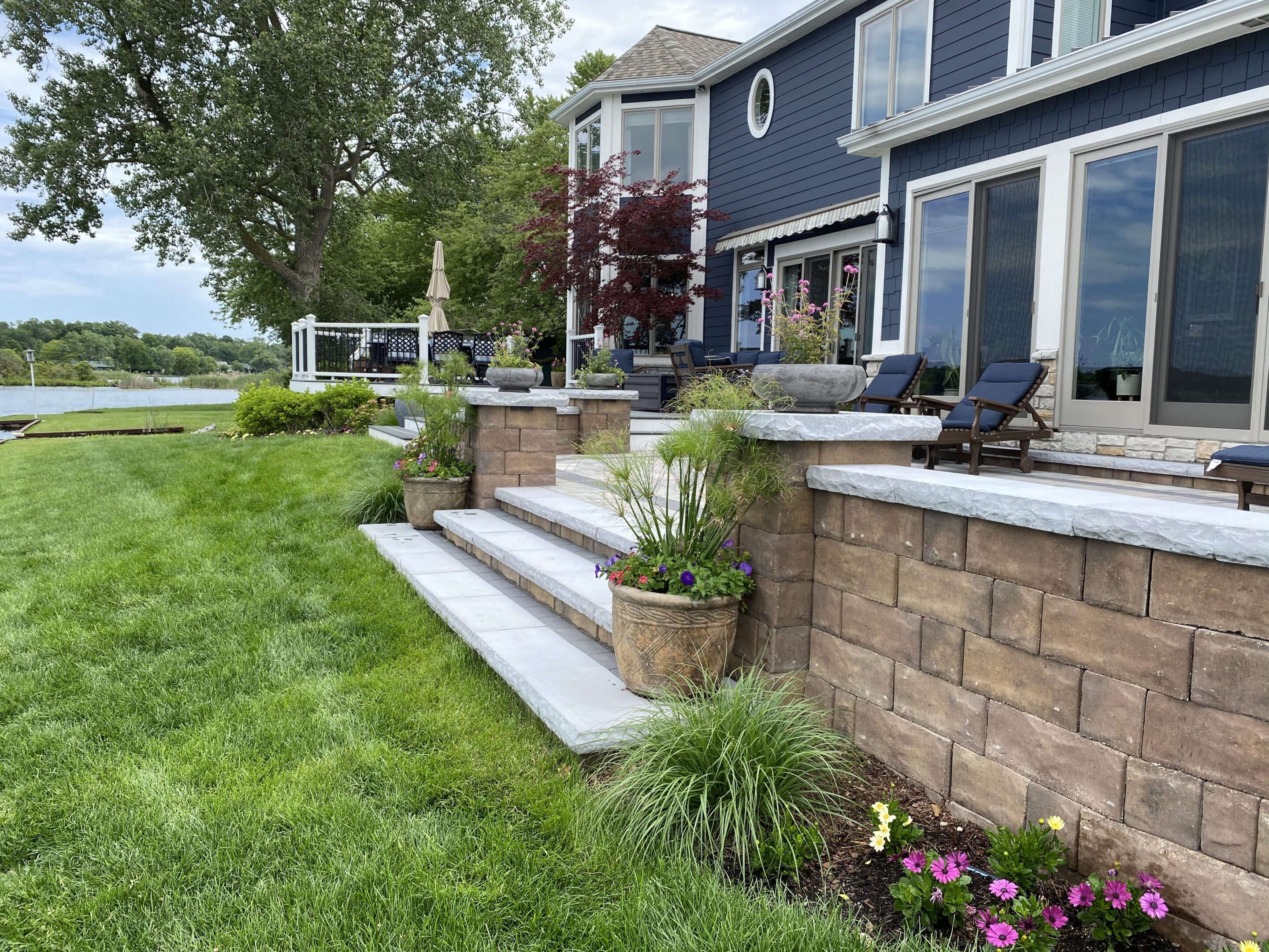 A house with steps and flowers in the yard.
